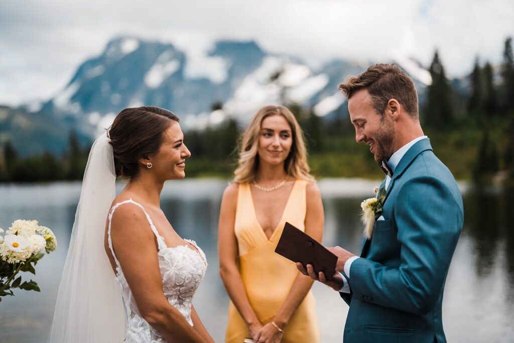 Groom reads vows to bride during their Washington micro wedding ceremony in the North Cascades