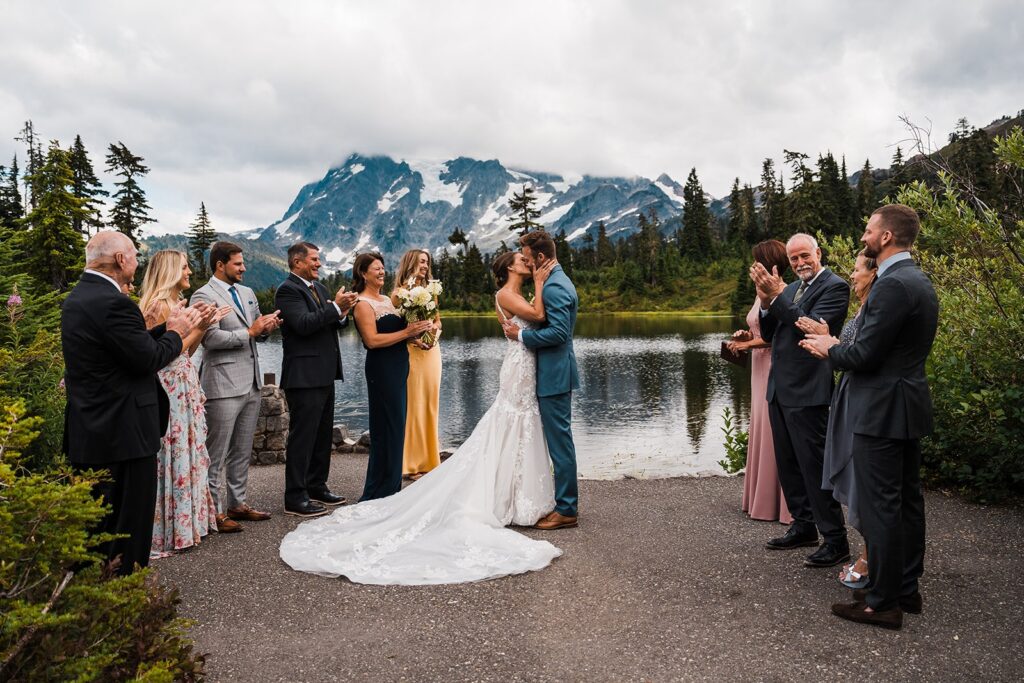 Bride and groom kiss during their micro wedding ceremony at Picture Lake