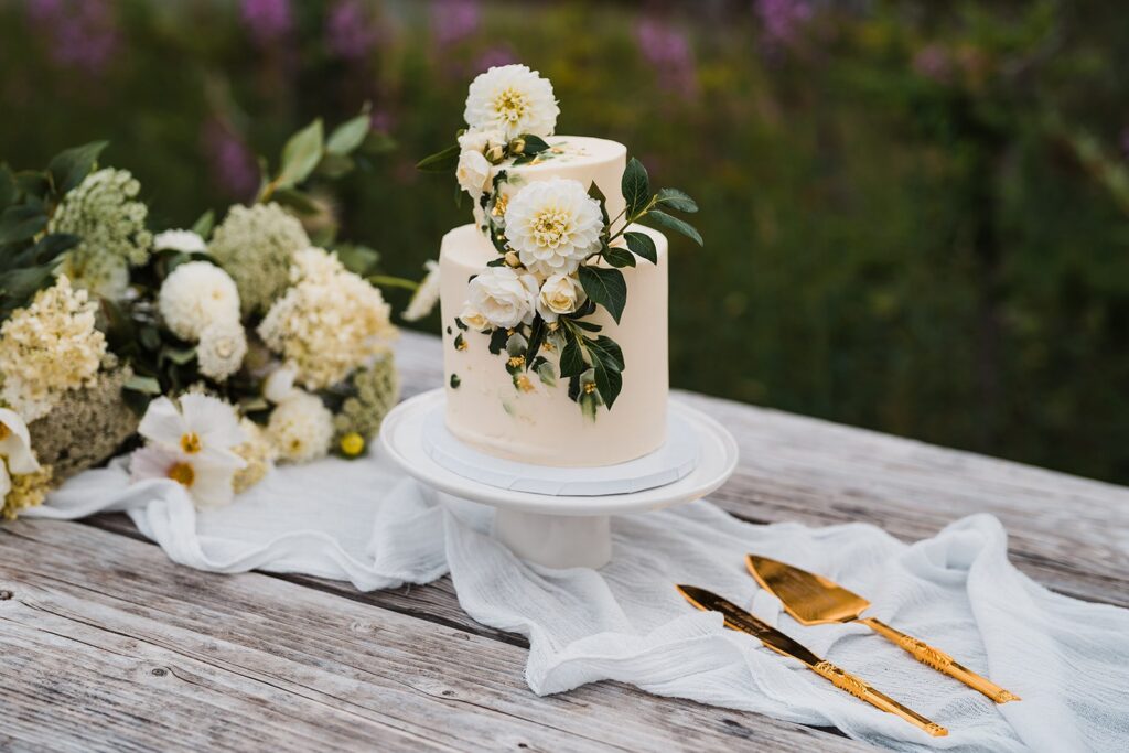 Two tier white wedding cake with white flowers