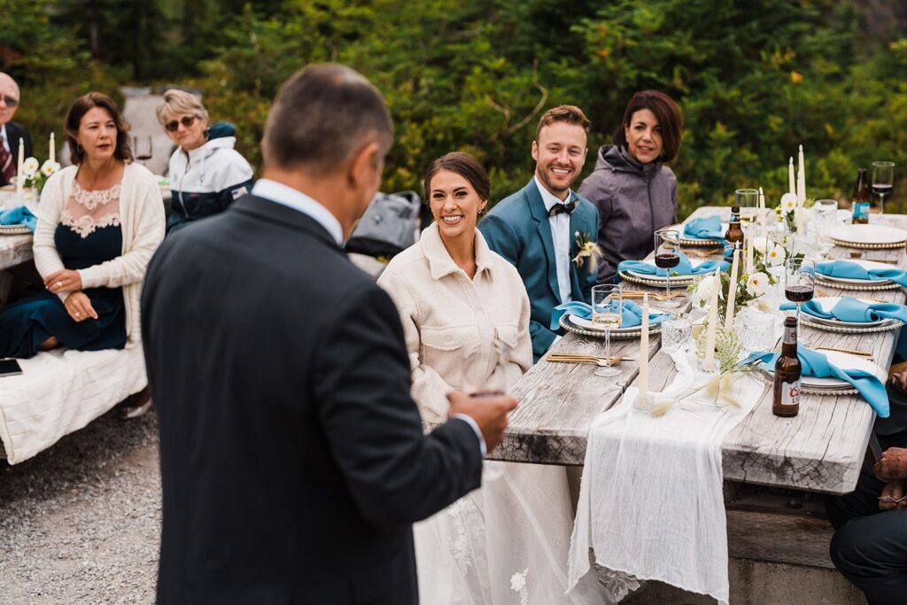 Loved ones toast the bride and groom during their celebratory meal in the North Cascades