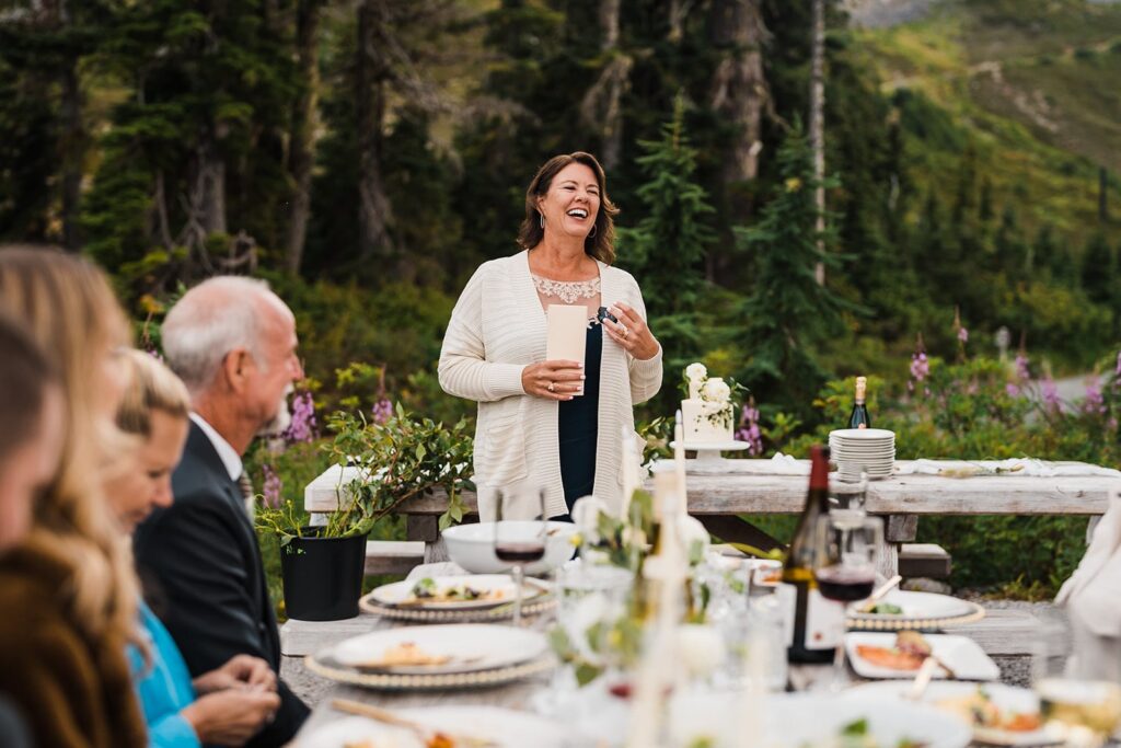 Loved ones toast the bride and groom during their celebratory meal in the North Cascades