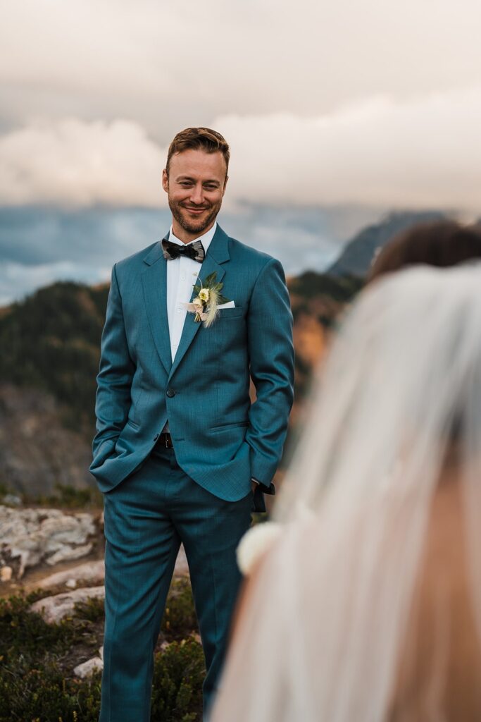Groom smiles at bride during their wedding photos in the North Cascades