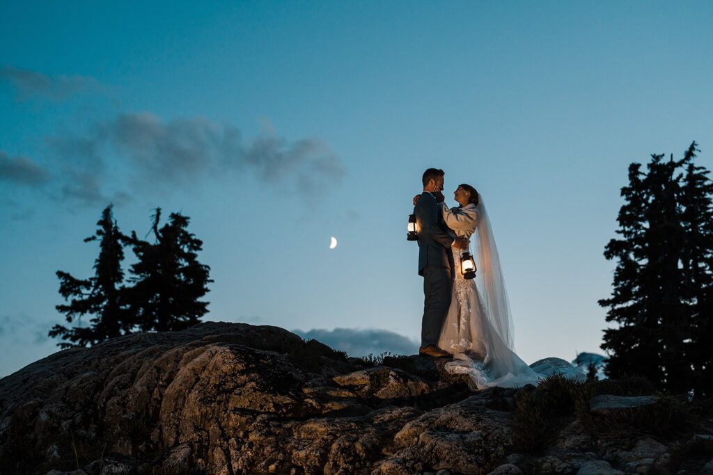 Bride and groom hold lanterns during their blue hour wedding photos in Washington