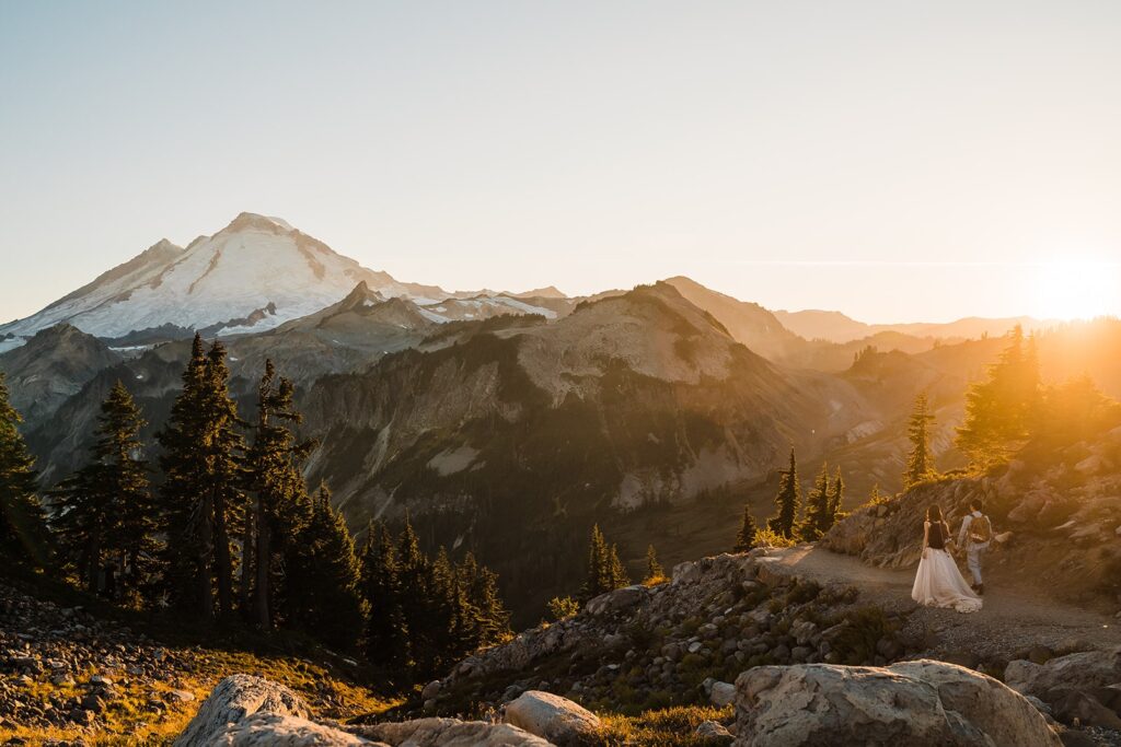 Bride and groom hold hands as they hike in the mountains during their North Cascades elopement
