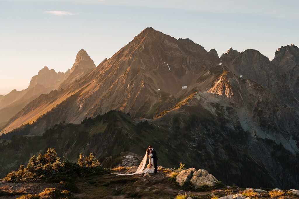 Bride and groom kiss on a mountain trail in the North Cascades during their Washington elopement 