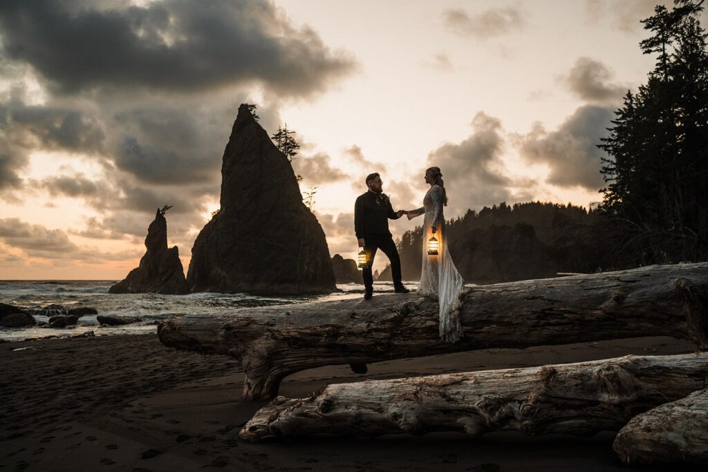 Bride and groom hold hands while standing on a fallen log during their elopement in Olympic National Park