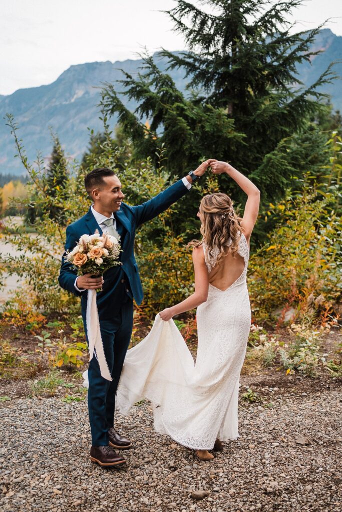 Groom spins bride around during their first look at their Pacific Northwest elopement in Snoqualmie
