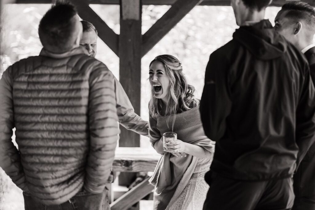 Bride laughs during a celebratory meal at her elopement in Snoqualmie