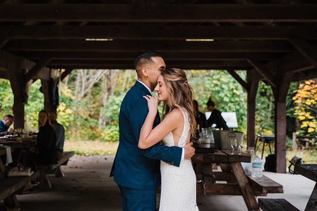 Bride and groom share a first dance in a covered pavilion at their Pacific Northwest elopement