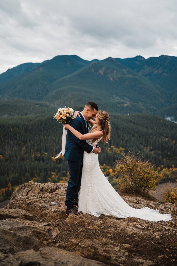 Bride and groom hug at a scenic overlook during their Pacific Northwest elopement