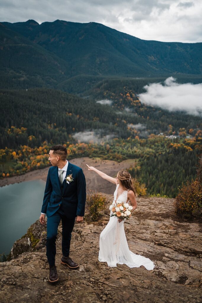 Bride and groom hike a mountain trail during their elopement in Snoqualmie
