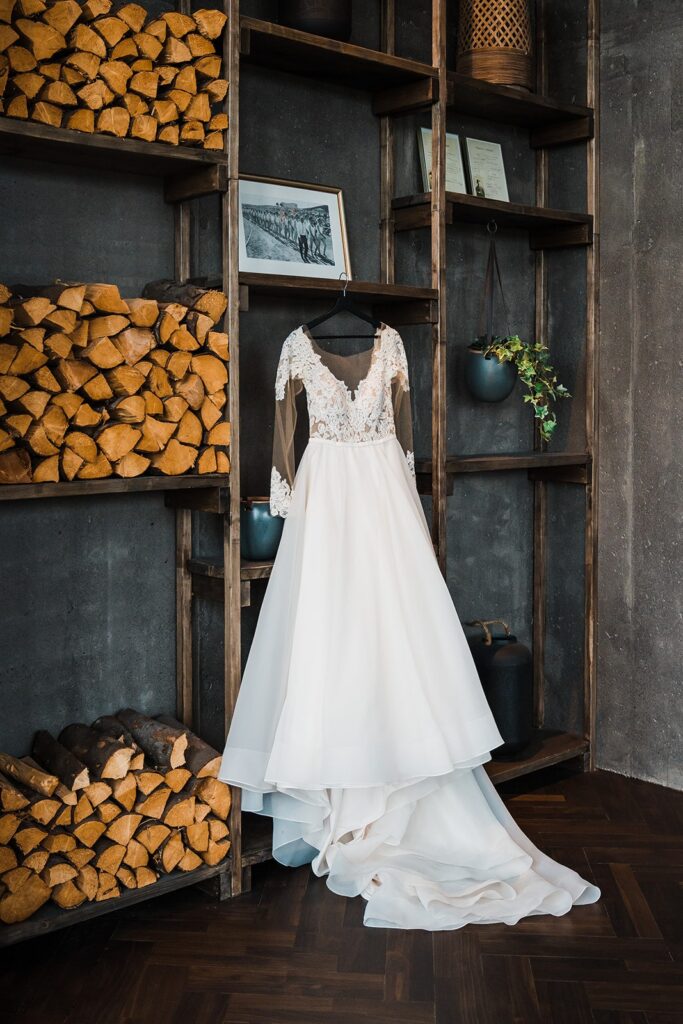 White wedding dress hanging from an industrial wall shelf at Hotel Geysir in Iceland