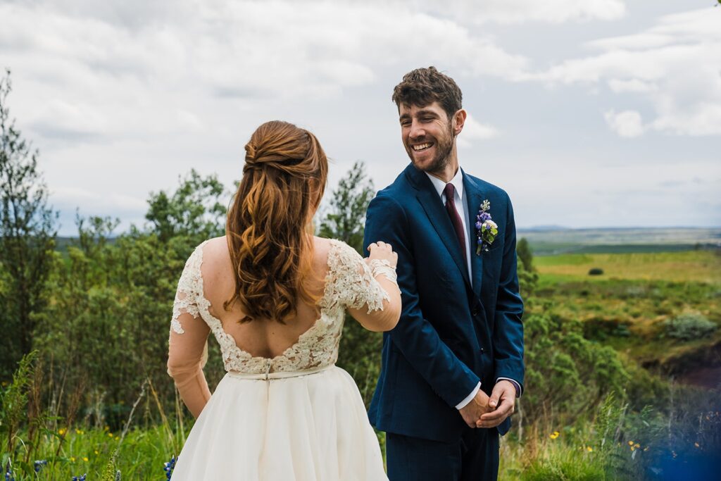 Groom turns around during elopement first look in Iceland 