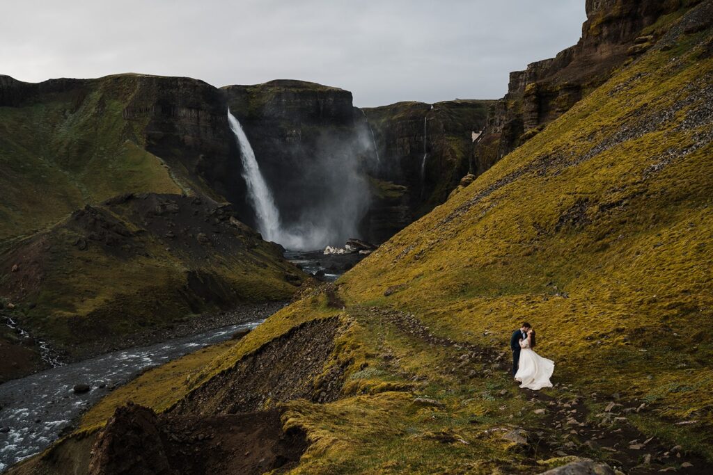 Bride and groom kiss on a hiking trail during their elopement in Iceland