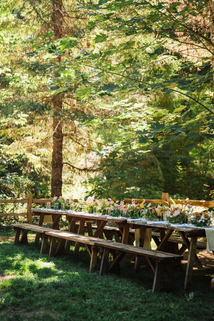 Wood picnic tables set up for a micro wedding reception at Wellspring Spa