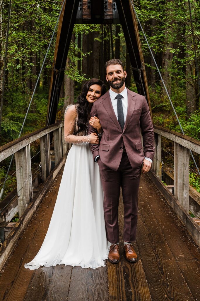 Bride holds groom's arm during their elopement in Snoqualmie