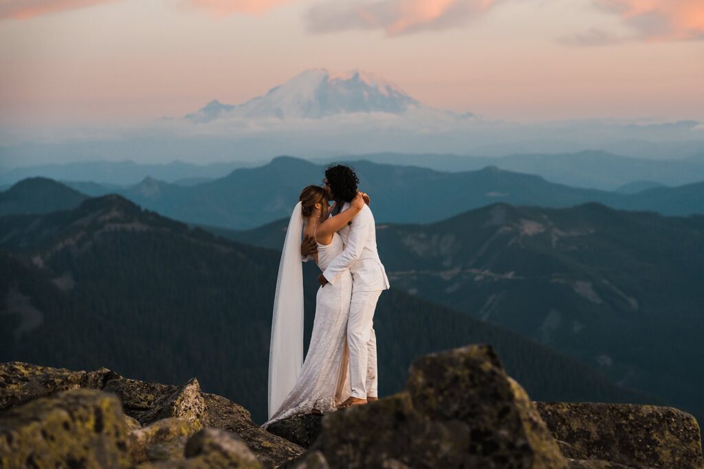 Bride and groom kiss on top of a mountain in Snoqualmie