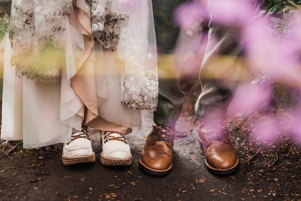 Bride and groom wear hiking boots during their rainy North Cascades wedding