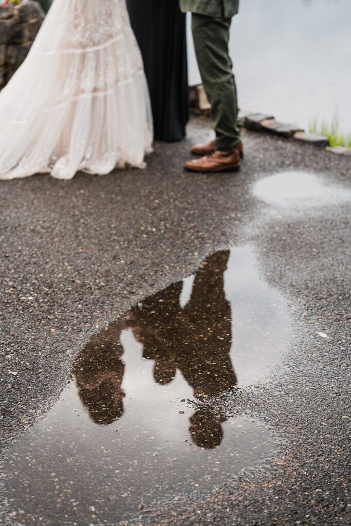 Reflection of bride and groom in a puddle in the North Cascades