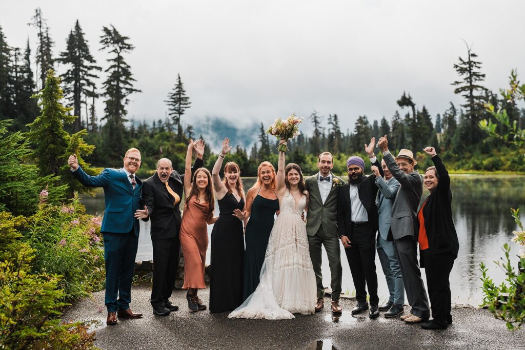 Bride and family members cheer after a rainy wedding ceremony in the North Cascades