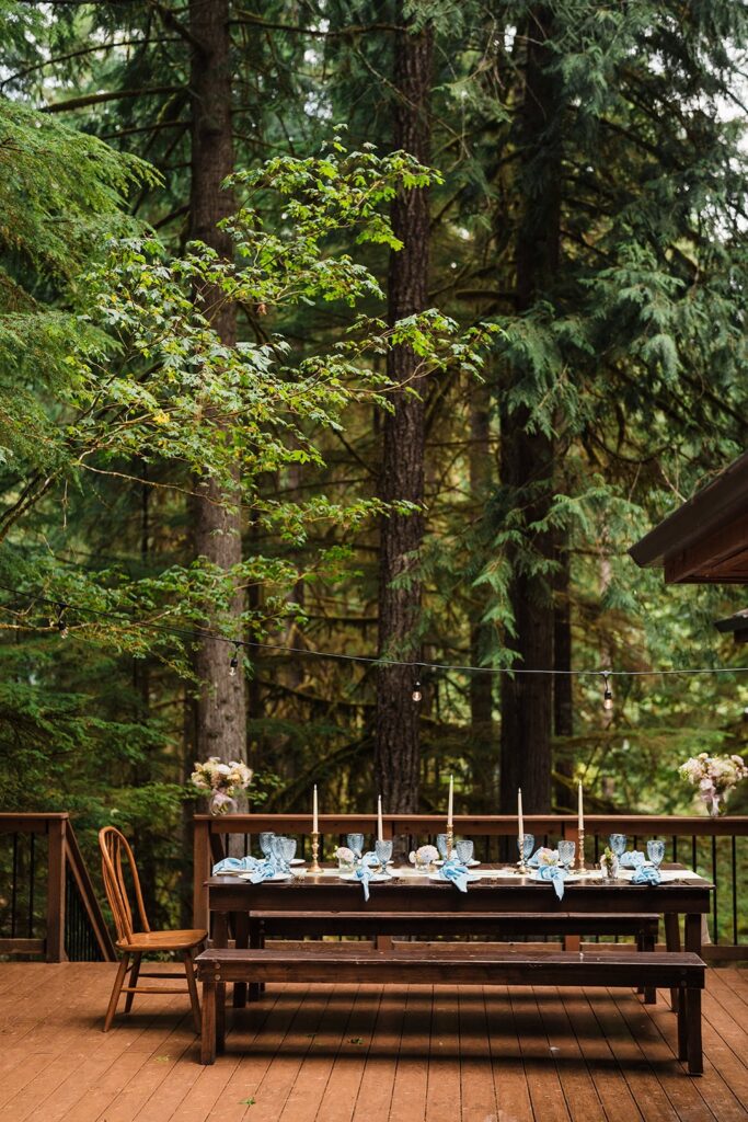 Wood picnic table in the forest decorated for a rainy wedding reception