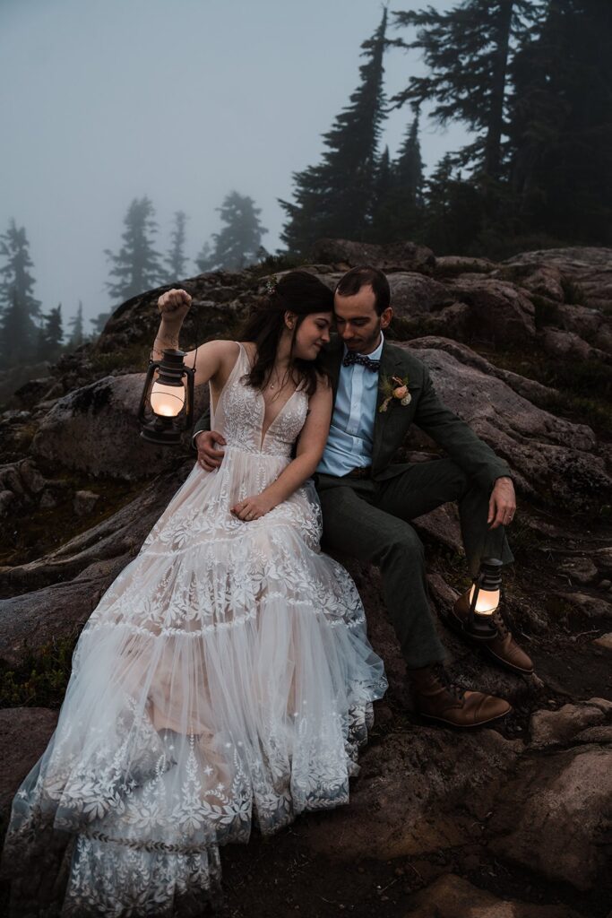 Bride and groom hold lanterns during their blue hour wedding photos in the North Cascades