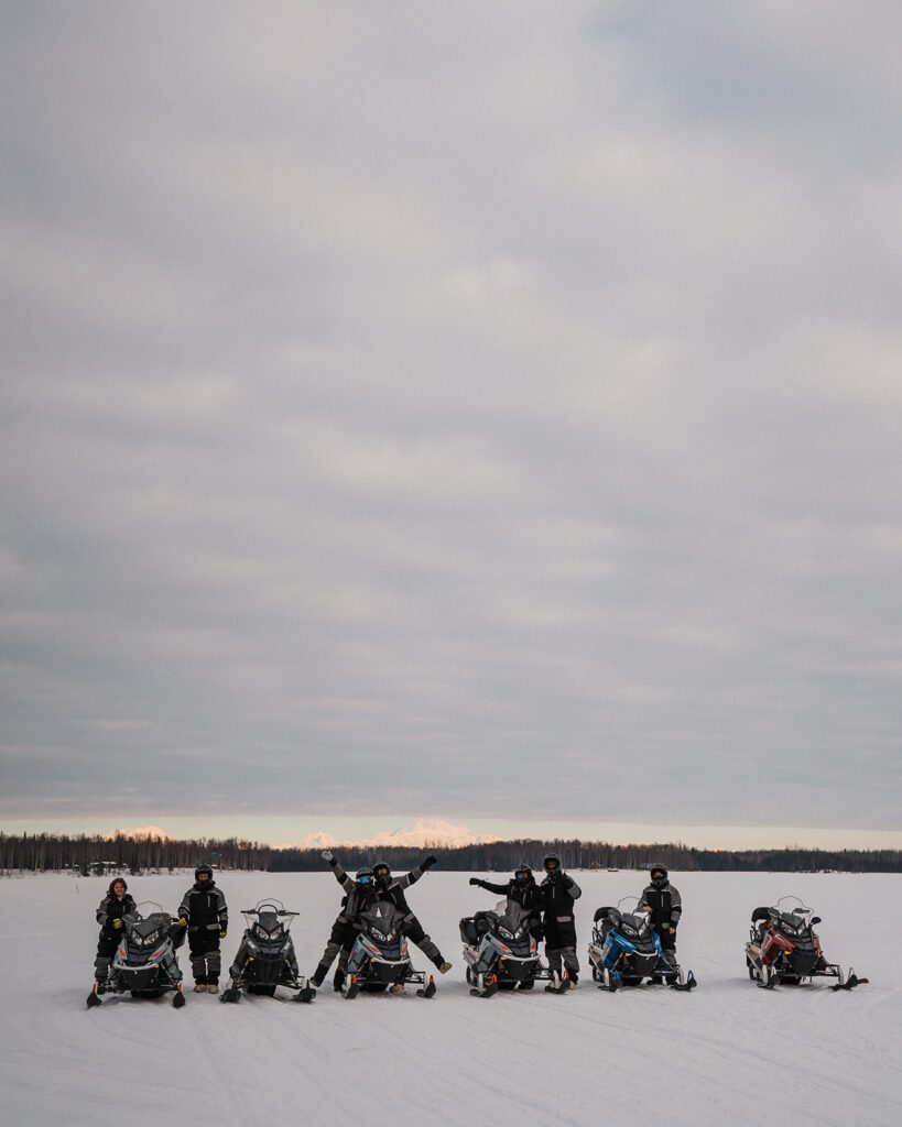 Family snowmobiles during their Alaska elopement adventure 