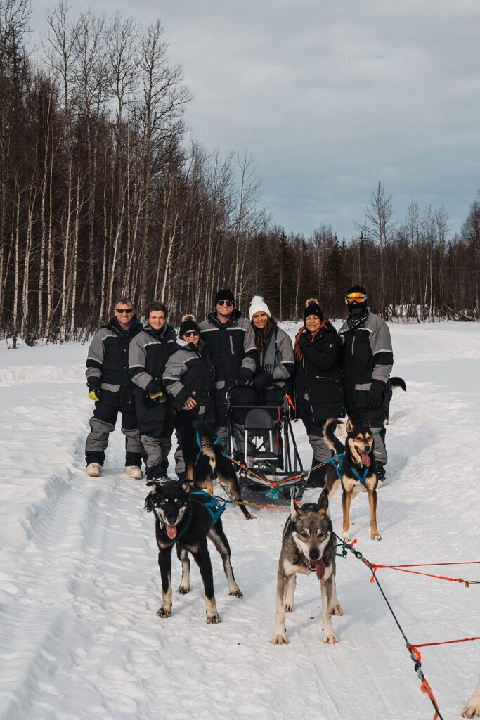 Family enjoys a dog-sledding ride during their Alaska elopement