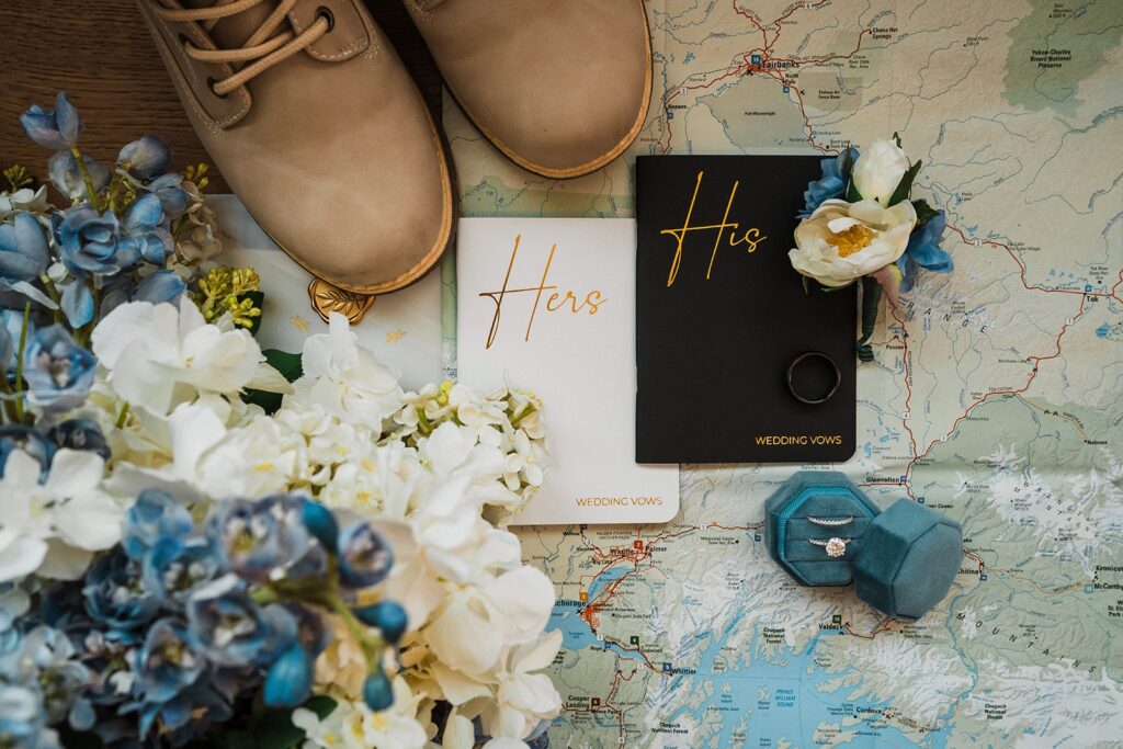 White and blue elopement details with his and hers vow books 