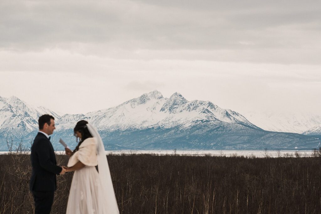 Bride and groom exchange private vows during their elopement in Alaska 