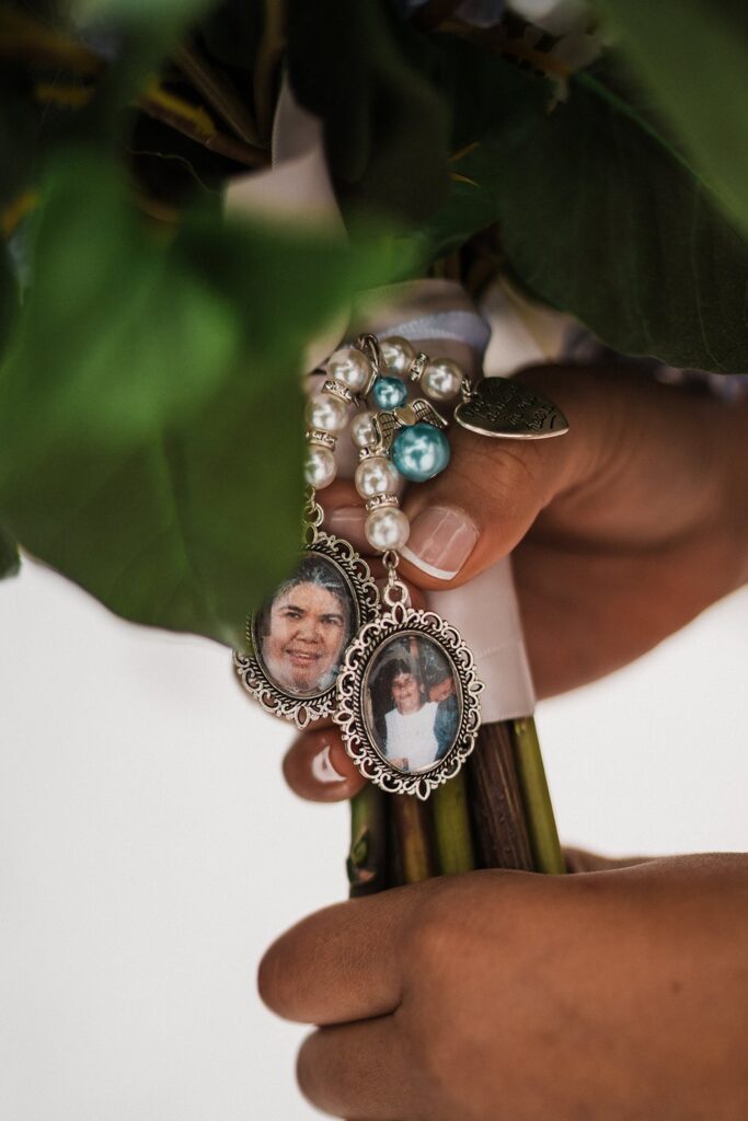 Locket hangs from elopement flower bouquet 