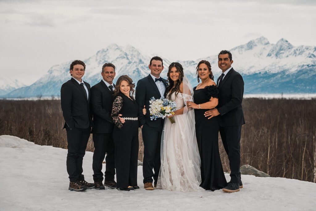 Family wedding portrait in the snow during Alaska glacier elopement