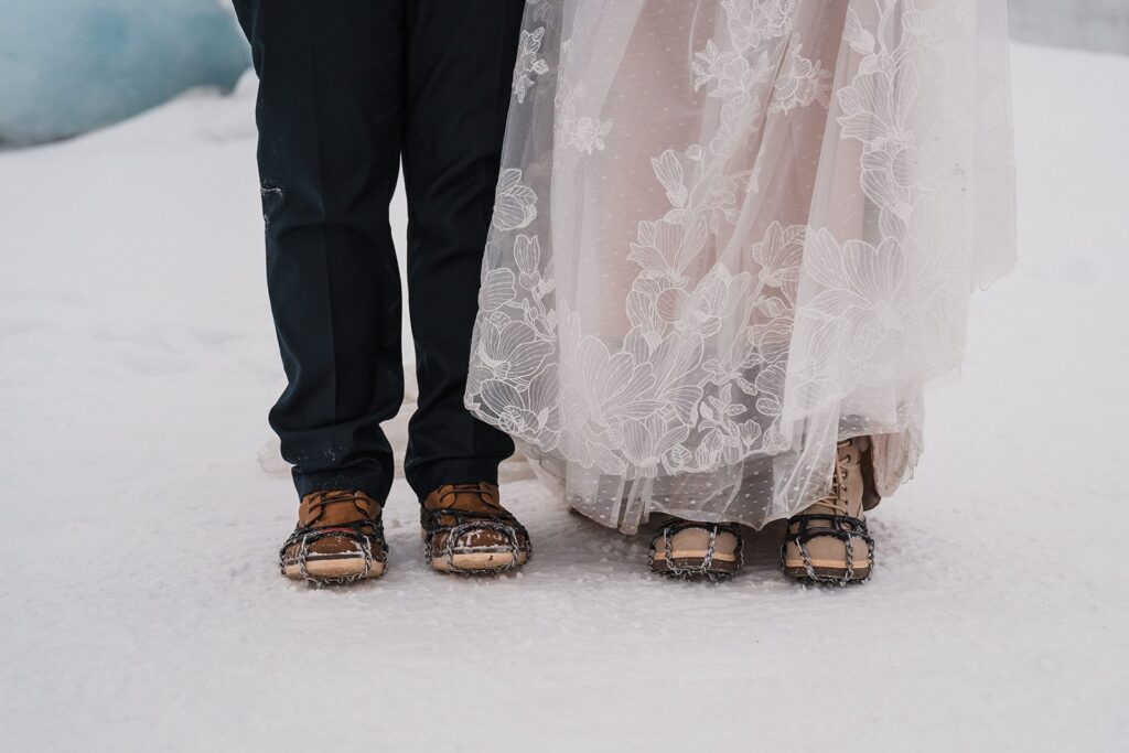 Bride and groom wear chains on their hiking boots during their Alaska glacier elopement