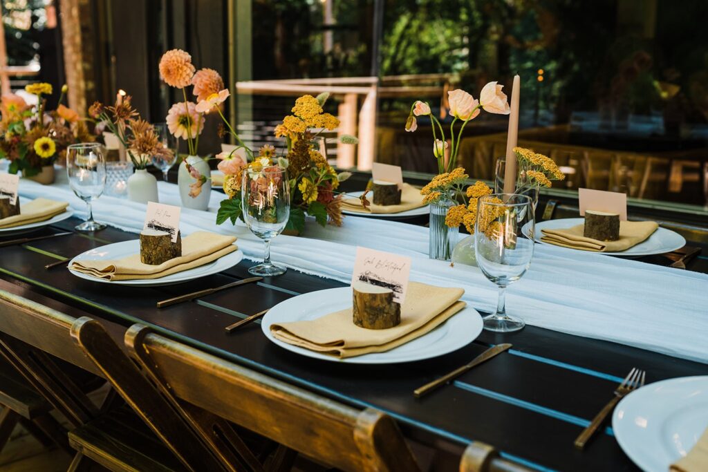 Orange flowers in bud vases at the Perch micro wedding venue reception