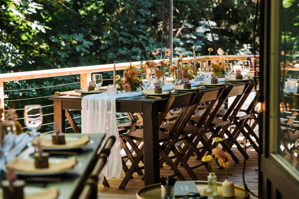 Wood wedding reception table on a deck at The Perch micro wedding venue in Washington