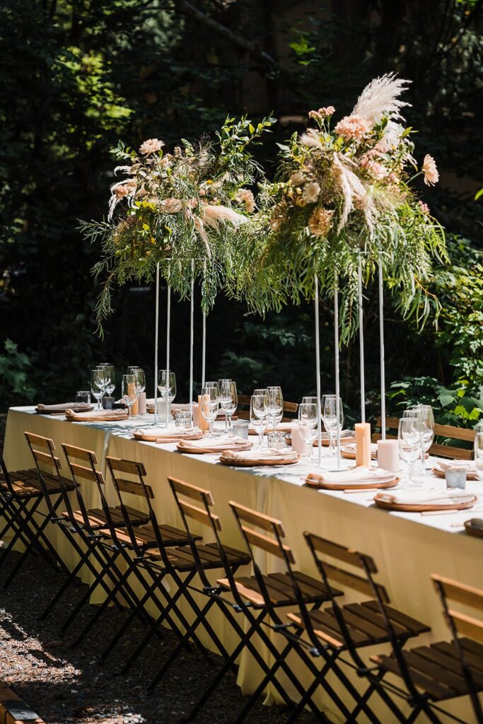 Tall floral arrangements on an outdoor dinner reception table at Mt Baker Getaways