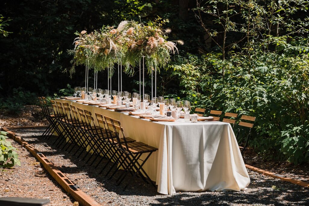 Outdoor wedding reception tables with tall floral arrangements at Mt Baker Getaways venue