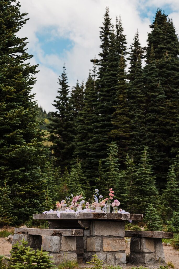 Pastel flowers line a picnic table in a day use area at Mt Rainier National Park