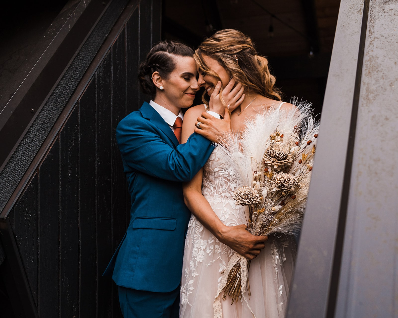 Brides hug during their wedding portraits at an A-frame cabin in Snoqualmie