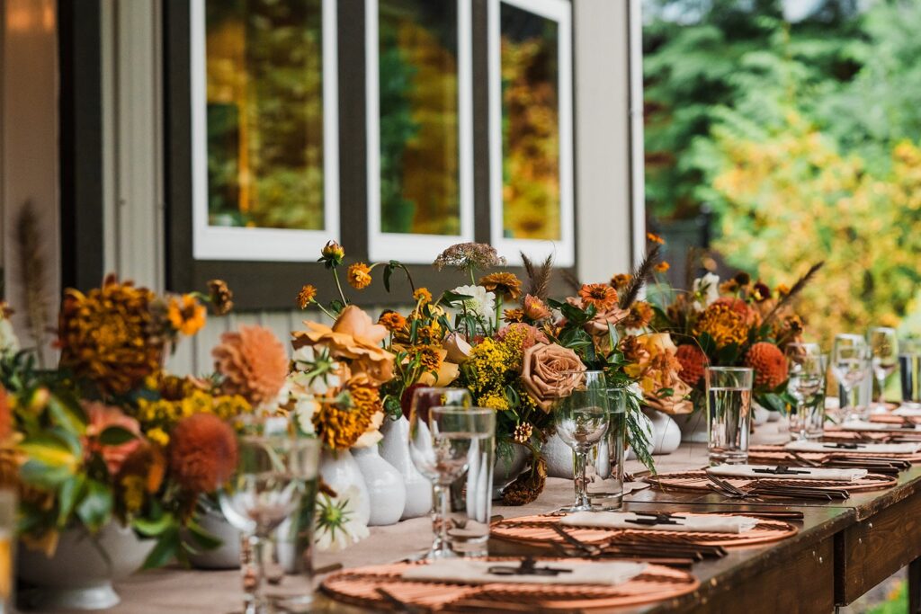 Orange flowers line a reception table at a North Cascades micro wedding venue