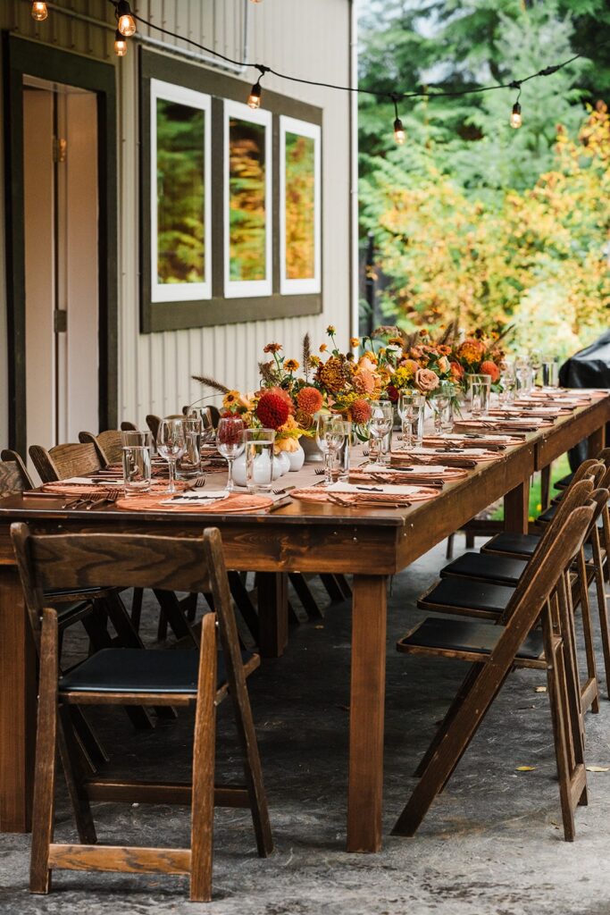 Orange flowers line a reception table at a North Cascades micro wedding venue