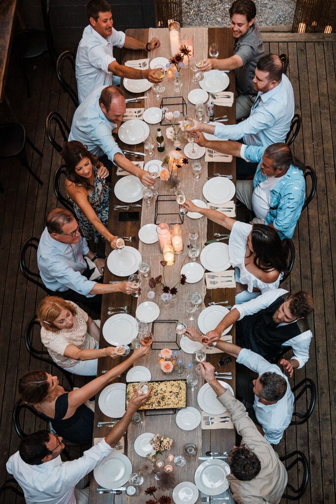 Guests toast at a banquet table at a Washington micro wedding venue