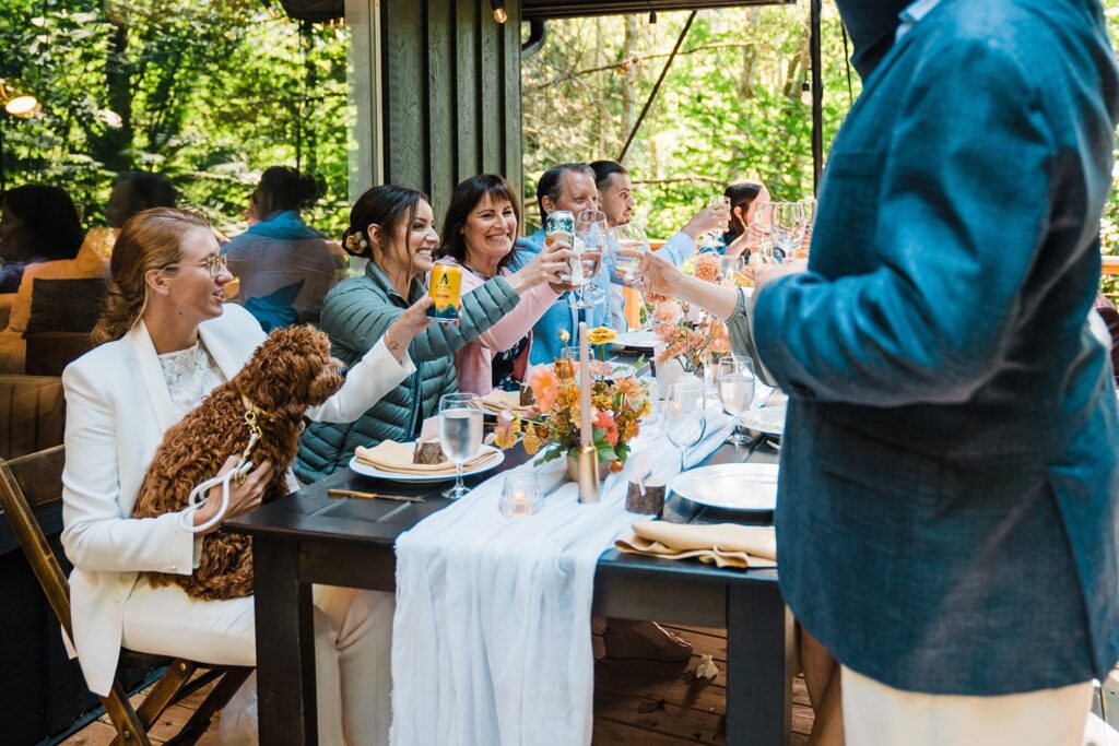 Guests toast to brides during The Perch micro wedding venue dinner reception