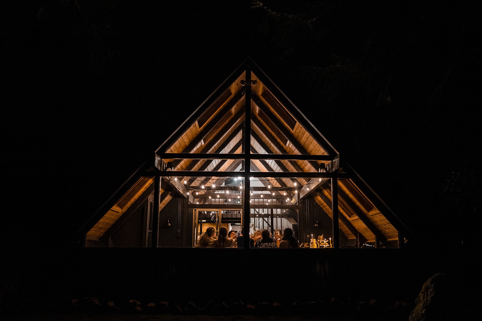 Guests enjoy a celebratory meal at an A-frame micro wedding venue in Washington