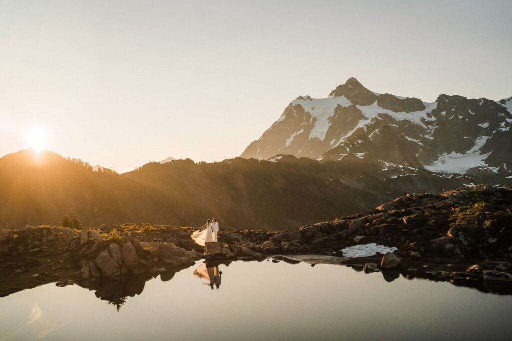 Bride lifts the train of her dress during sunset adventure elopement portraits in the North Cascades