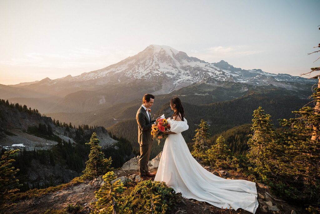 Bride and groom exchange vows during their adventure elopement at Mt Rainier 