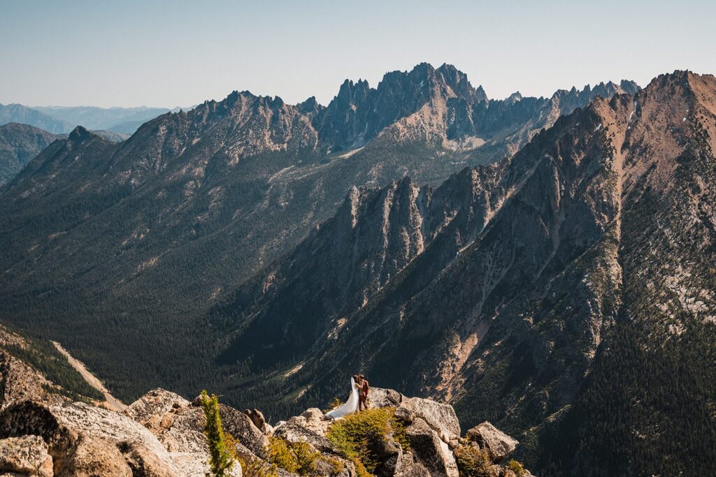 Bride and groom kiss during their adventure elopement in the mountains