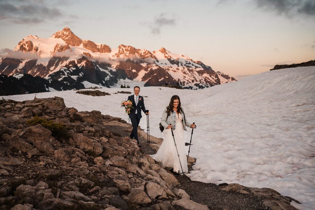 Bride and groom hike through the snow during their adventure elopement in Washington