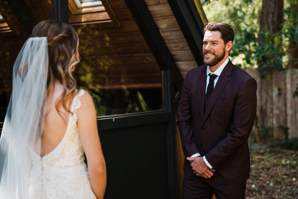 Groom turns around and smiles at bride during their elopement first look 