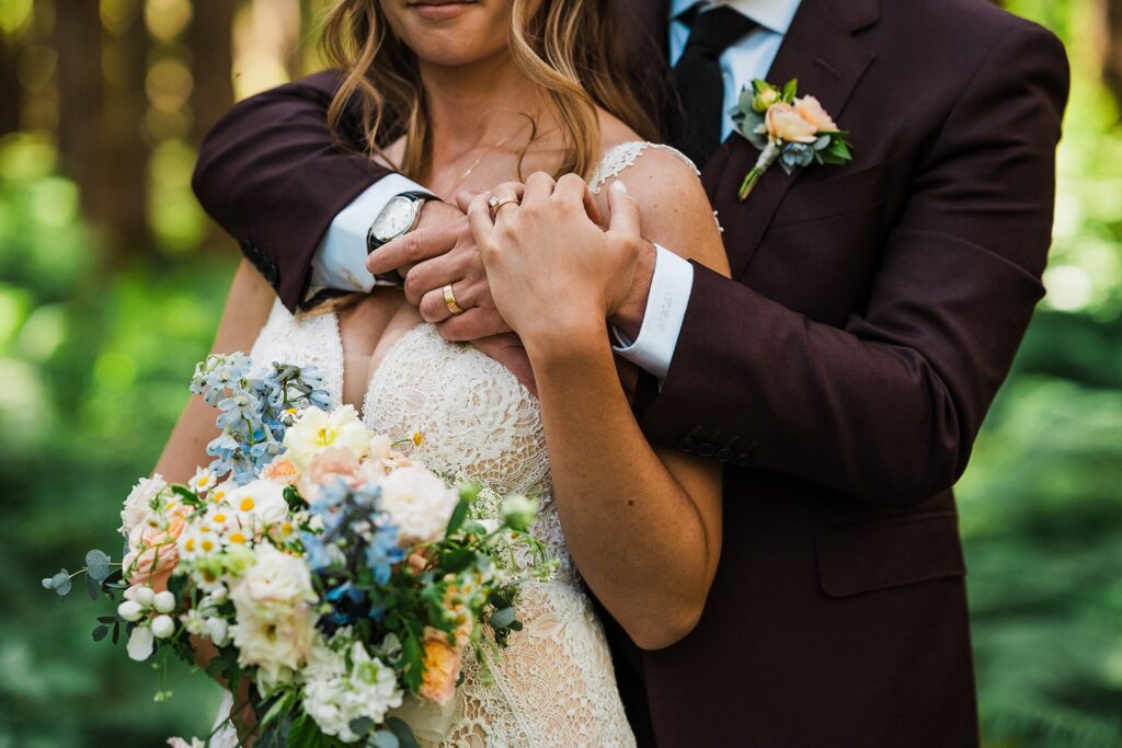 Groom wraps his arms around bride during their intimate wedding in Snoqualmie Valley